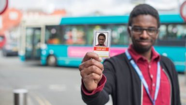 Picture of one of our students holding a bus pass
